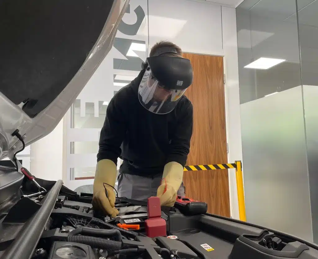 Man checking electric current on a electric vehicle